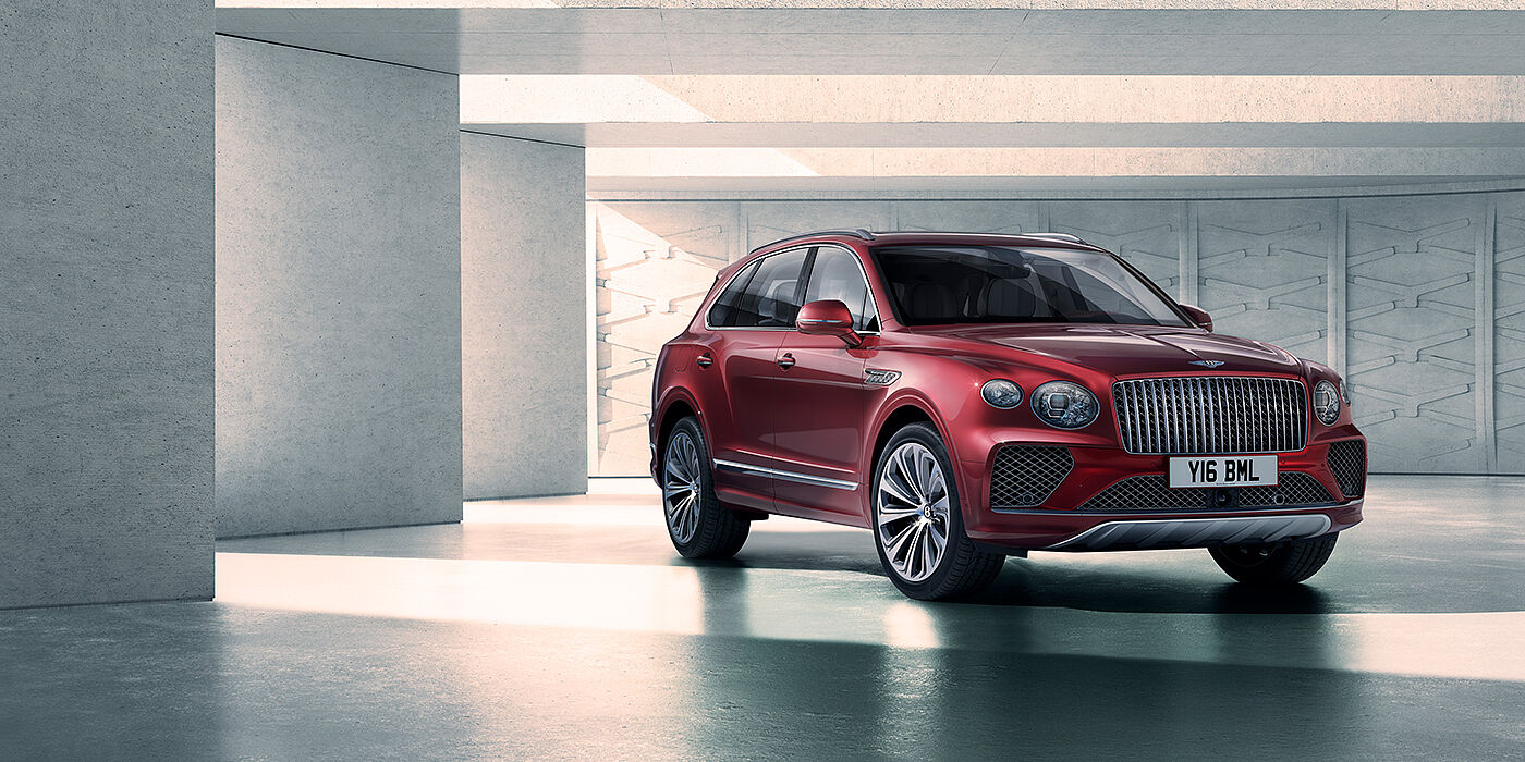 Bentley High Wycombe Bentley Bentayga Atelier Edition SUV in Rubino Red paint front three quarter against textured concrete wall