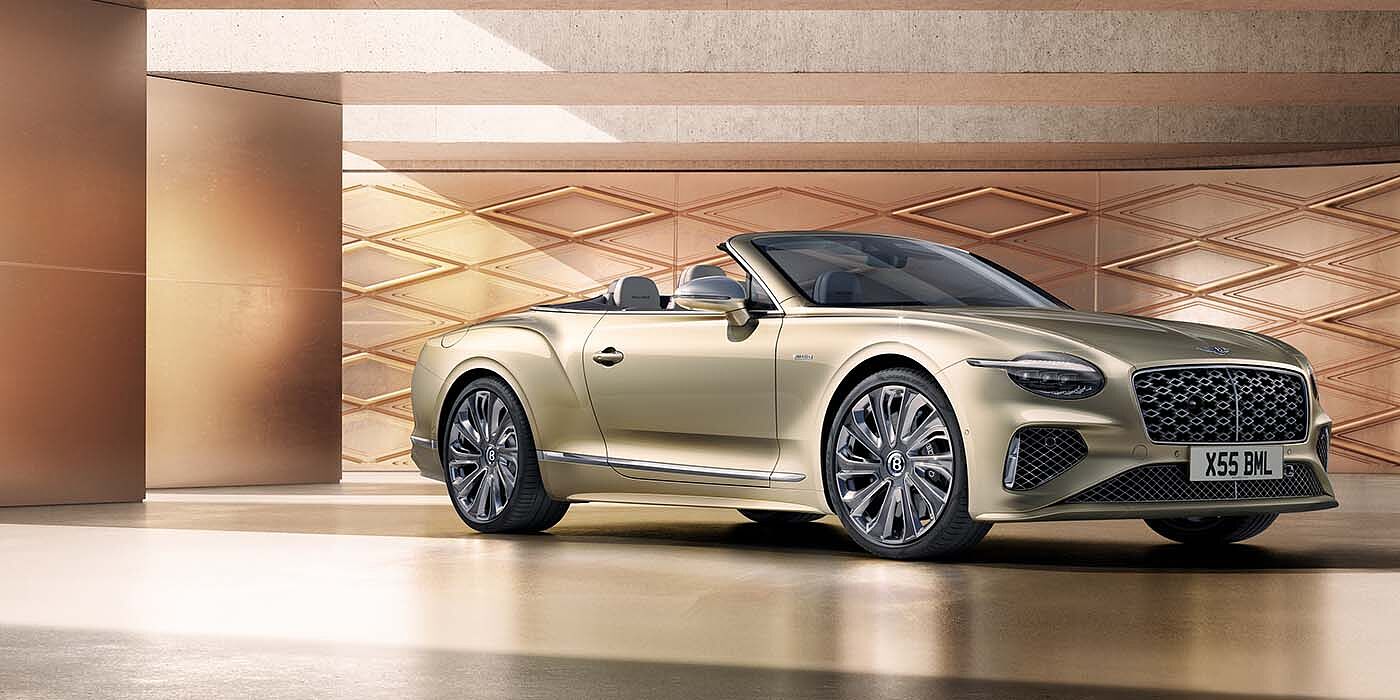 Bentley High Wycombe Bentley New Continental GTC Mulliner V8 hybrid front three quarters in Patina paint