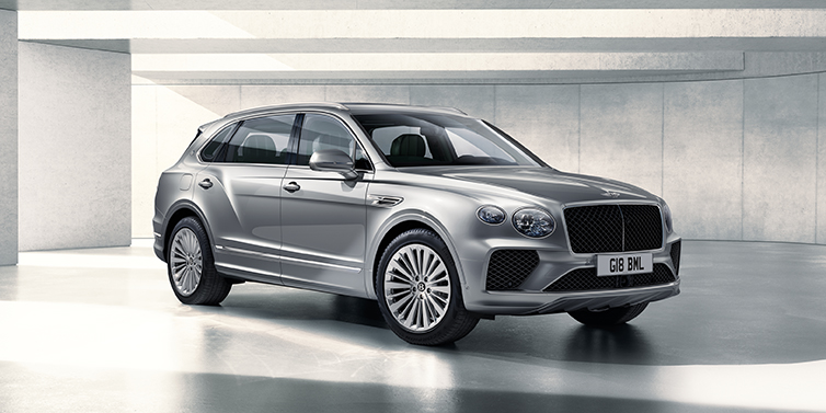 Bentley High Wycombe Bentley Bentayga Extended Wheelbase SUV front three quarter in Moonbeam paint with a grey background