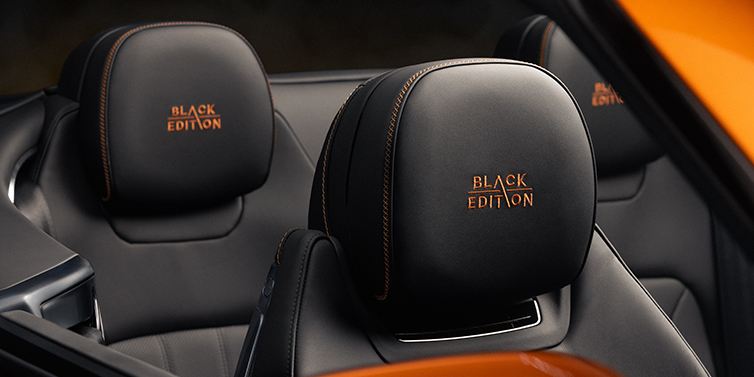 Bentley High Wycombe Bentley Continental GTC Black Edition convertible seat detail with Beluga black hide and Mandarin emblem stitching